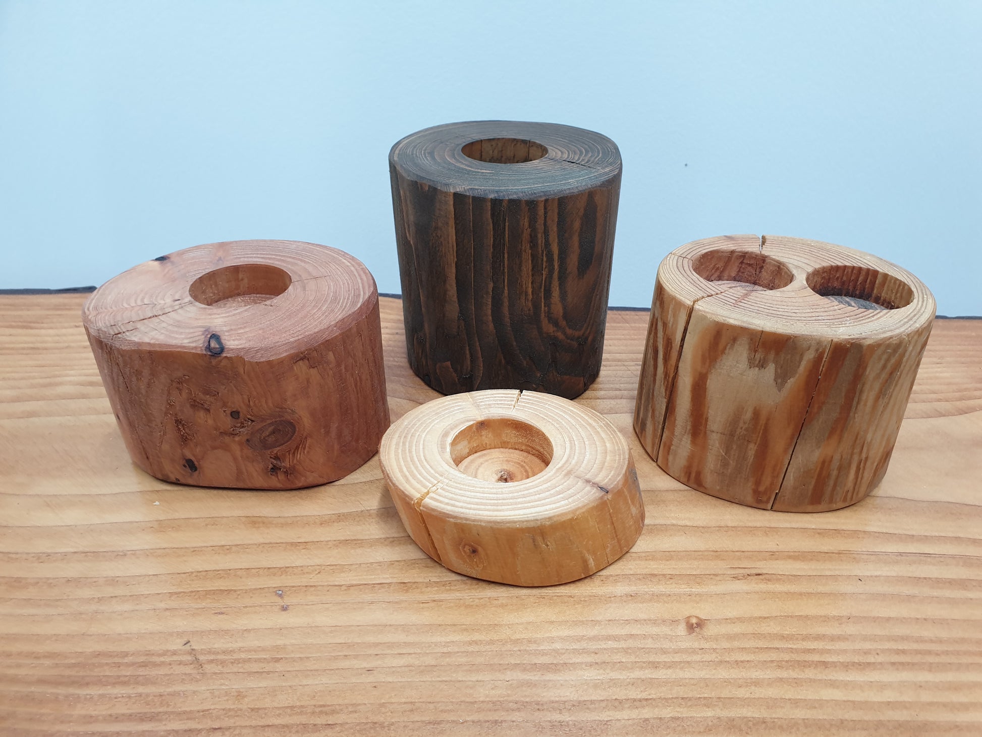 Log tea light holders of various heights and colours