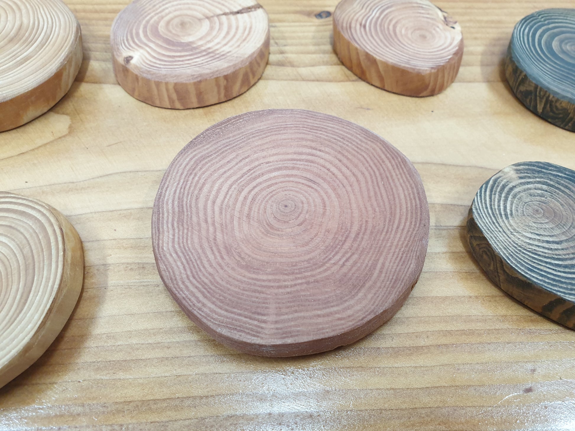 Closeup of a red cedar stained log ring coaster