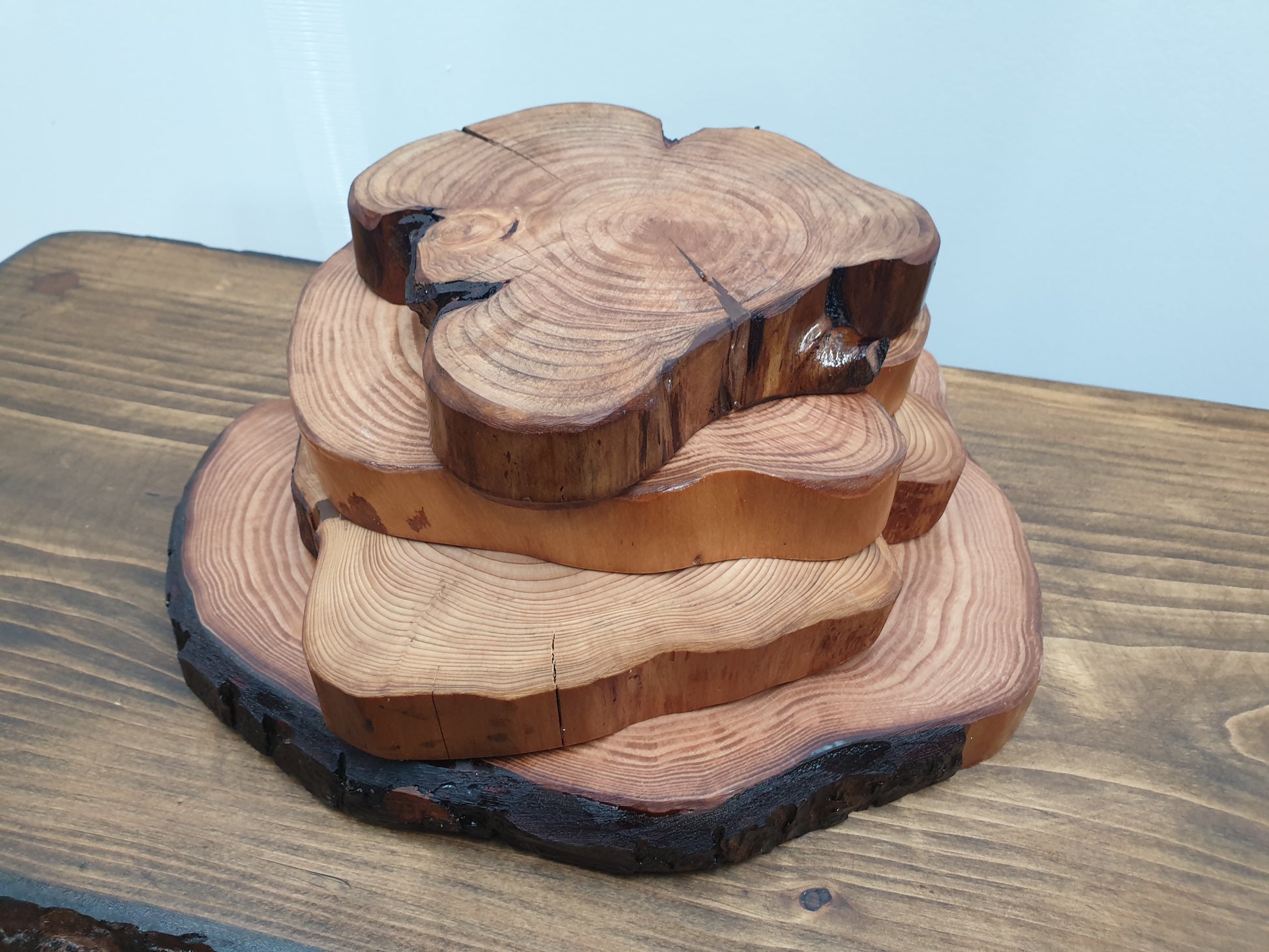 a stack of wooden log ring place mats of various sizes