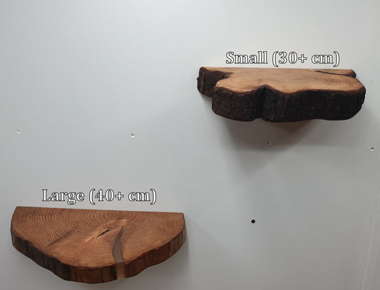 a pair of half log ring floating shelves mounted on a white wall with the labels "Small (30+ cm)" and "Large (40+ cm)"