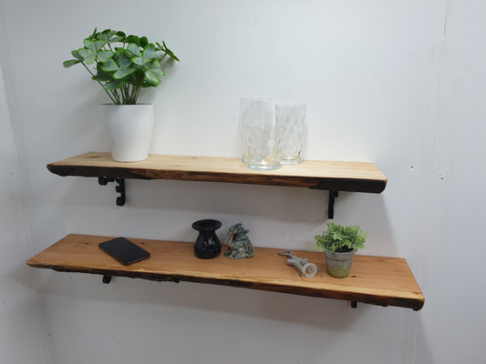 two live-edge wooden shelves with various items arranged on them