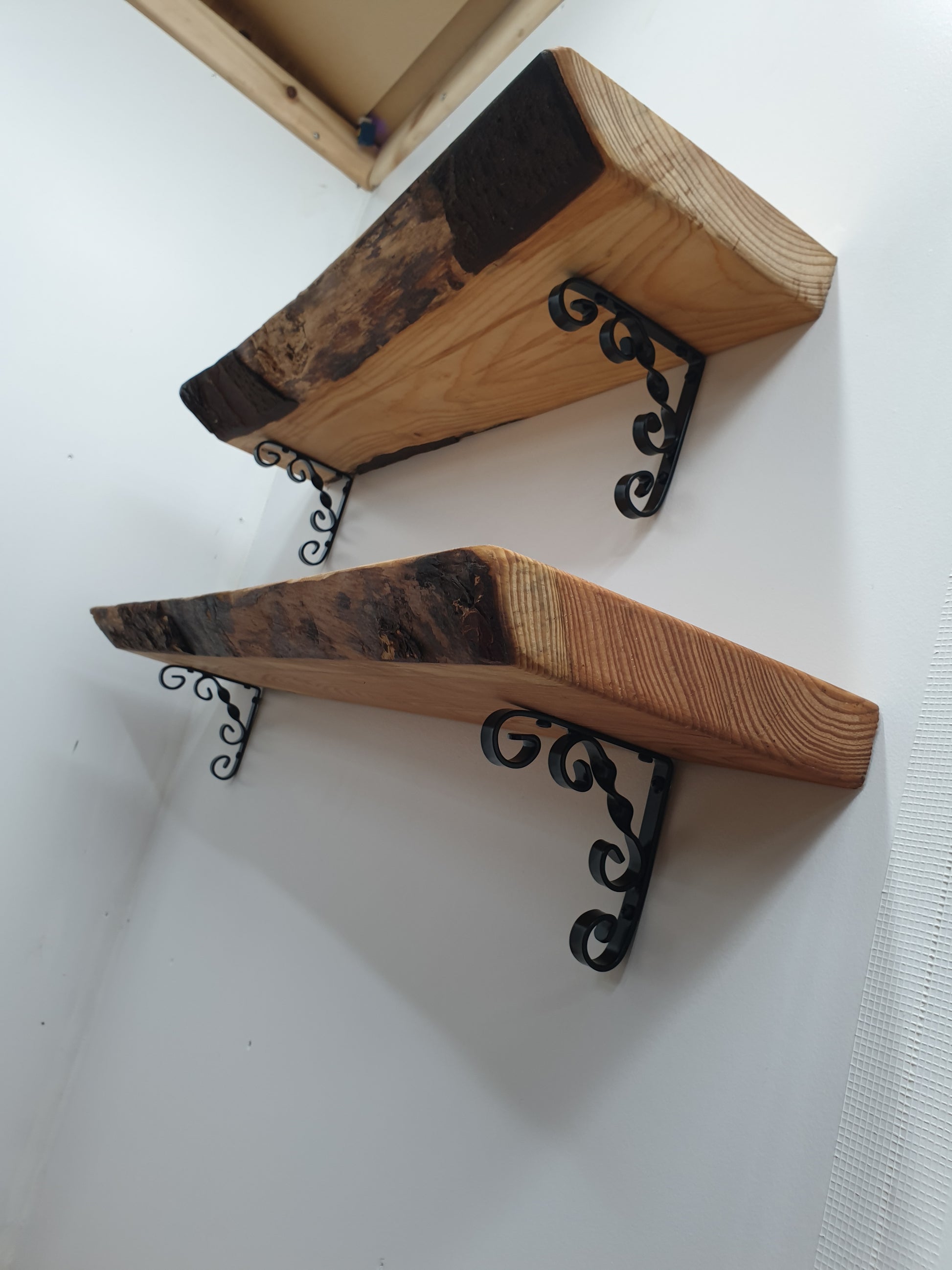 side view of some ornamental scroll shelves