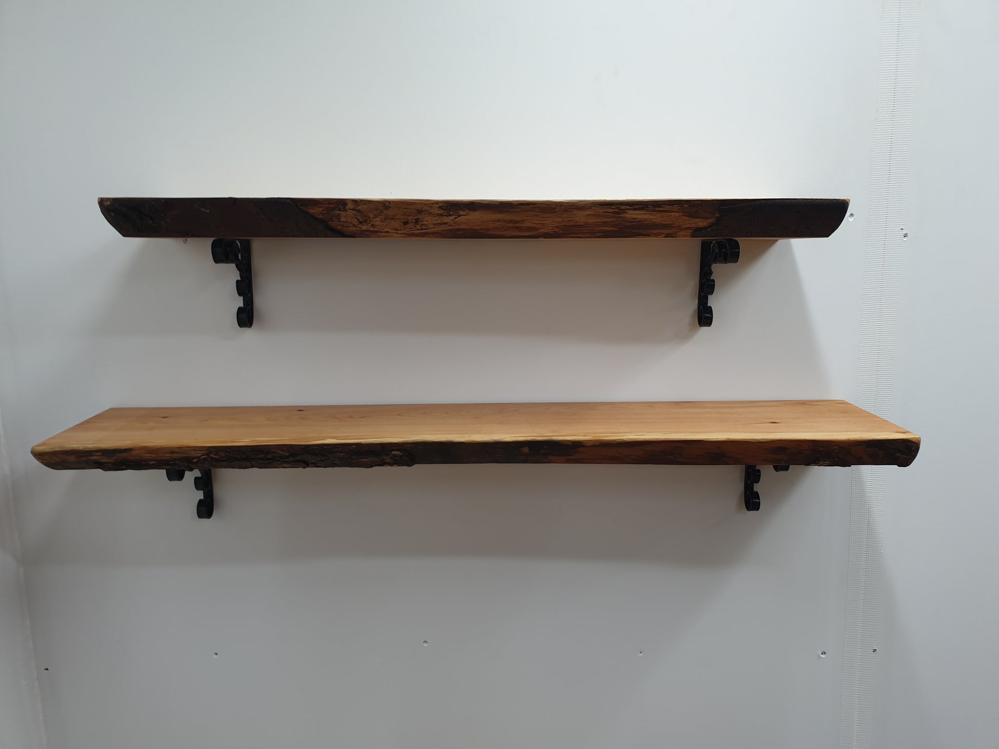 plain view of two wide wooden shelves showing their thickness