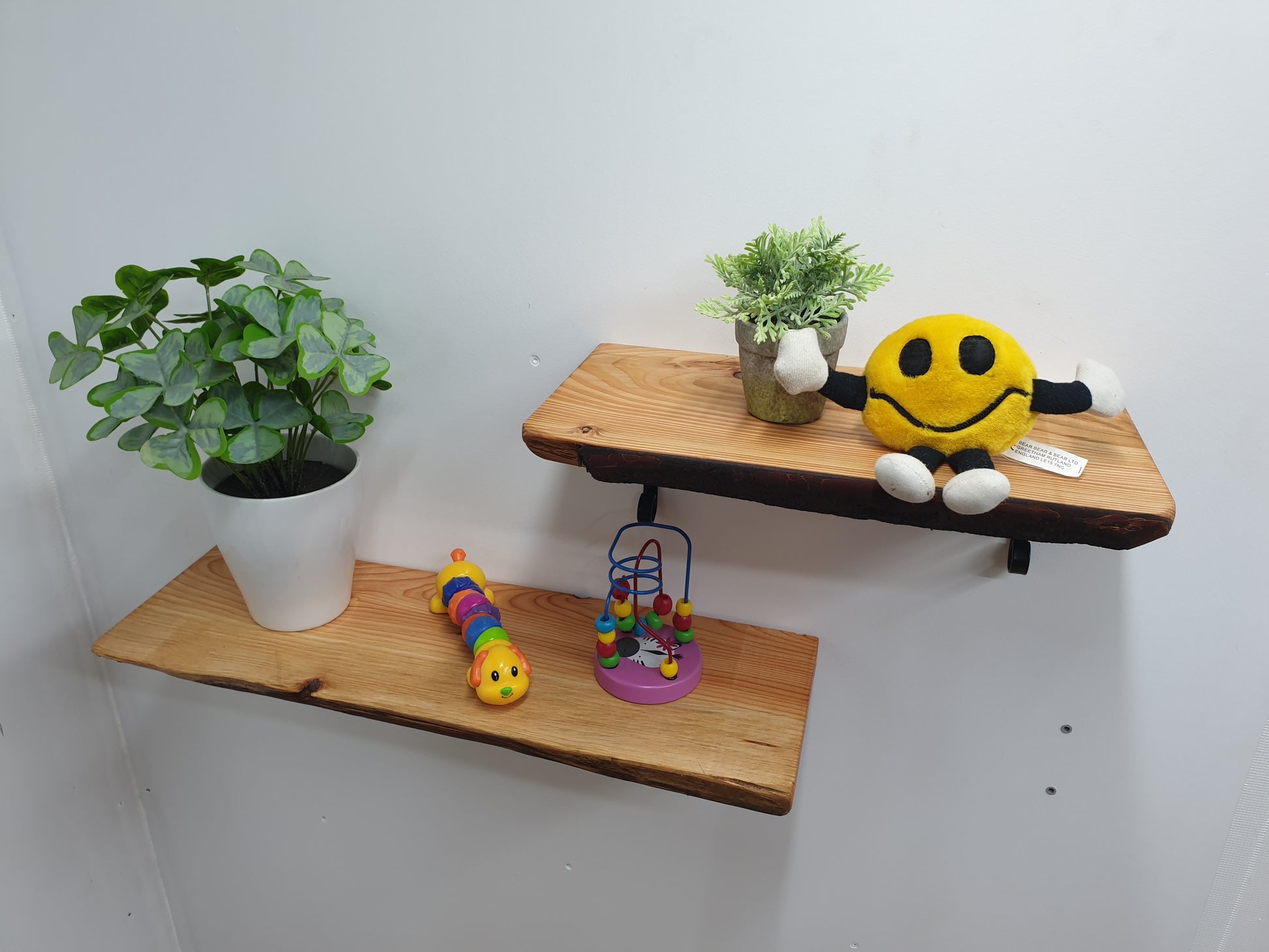 two short wooden shelves with childs toys on them