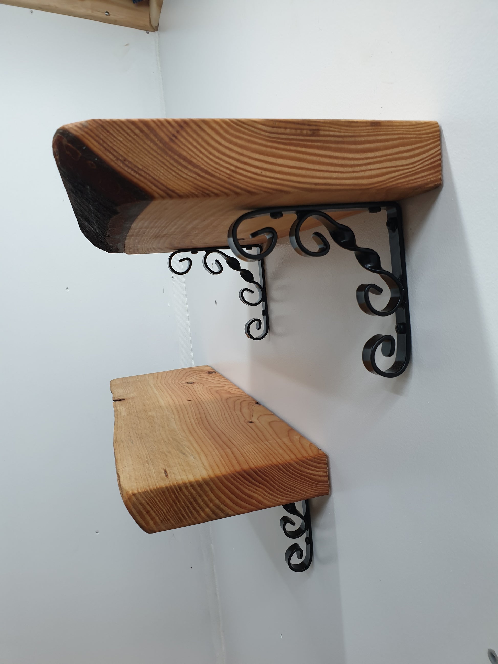 close up of an ornamental scroll bracket being used to hold a shelf