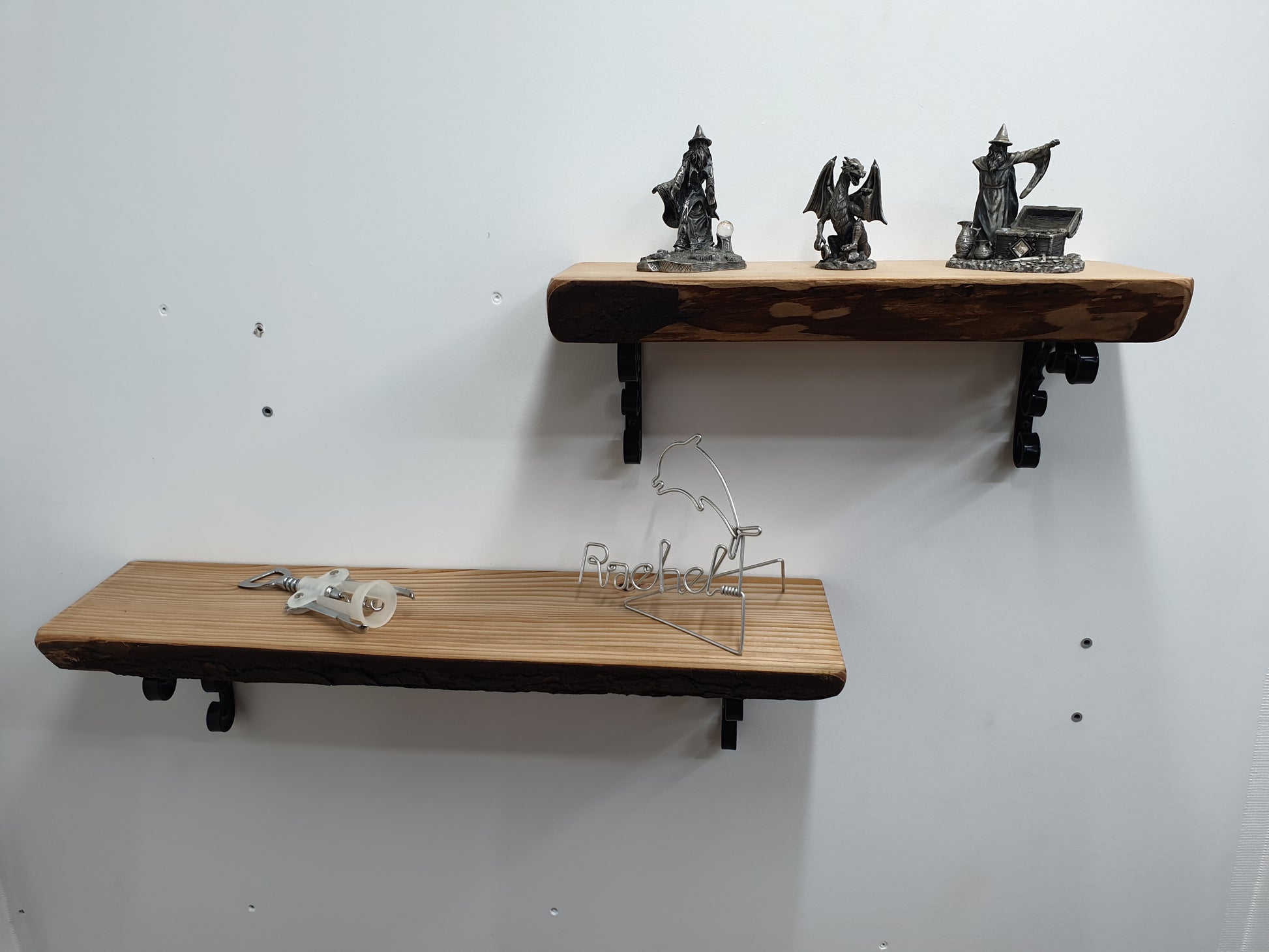 two short wooden shelves with fantasy ornaments arranged on them