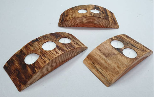 three nevvie tea light holders and candles, each made to hold three, two, and two candles respectively