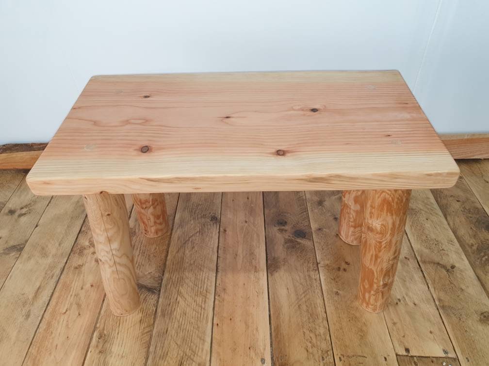 The wooden coffee table is now empty. Perhaps the owner of the table has gone out on an errand.