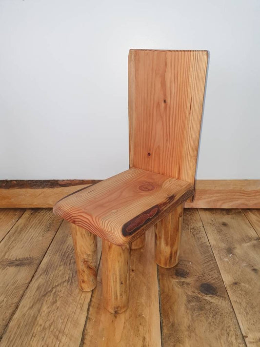 A tilted view of a kids throne against a studio background