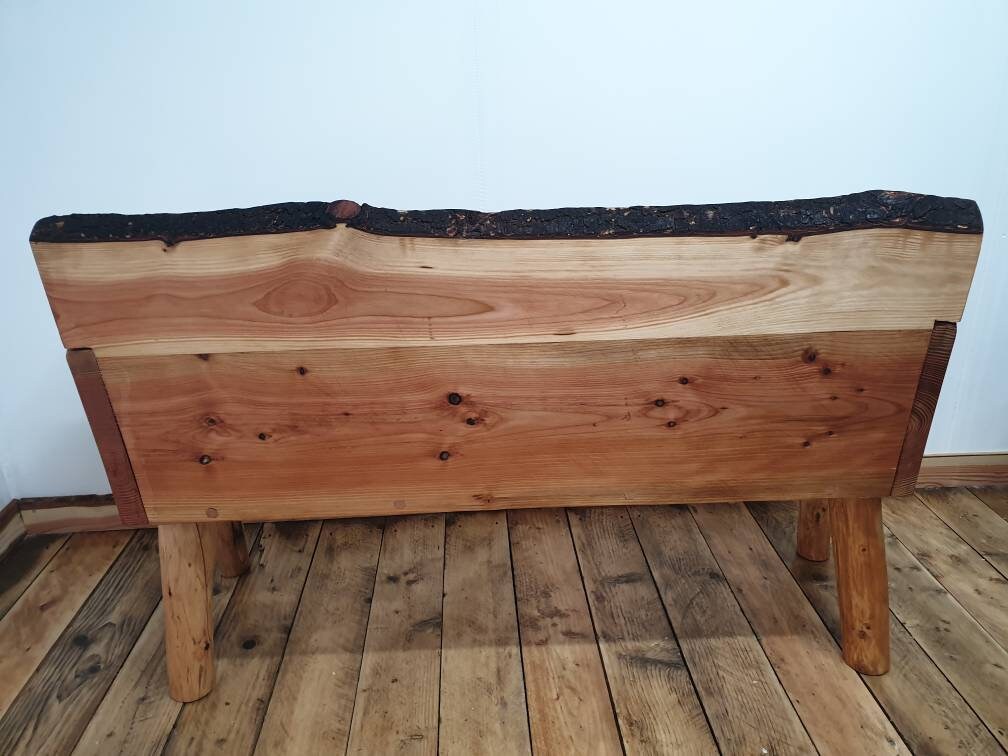 Back view of a solid backed garden bench