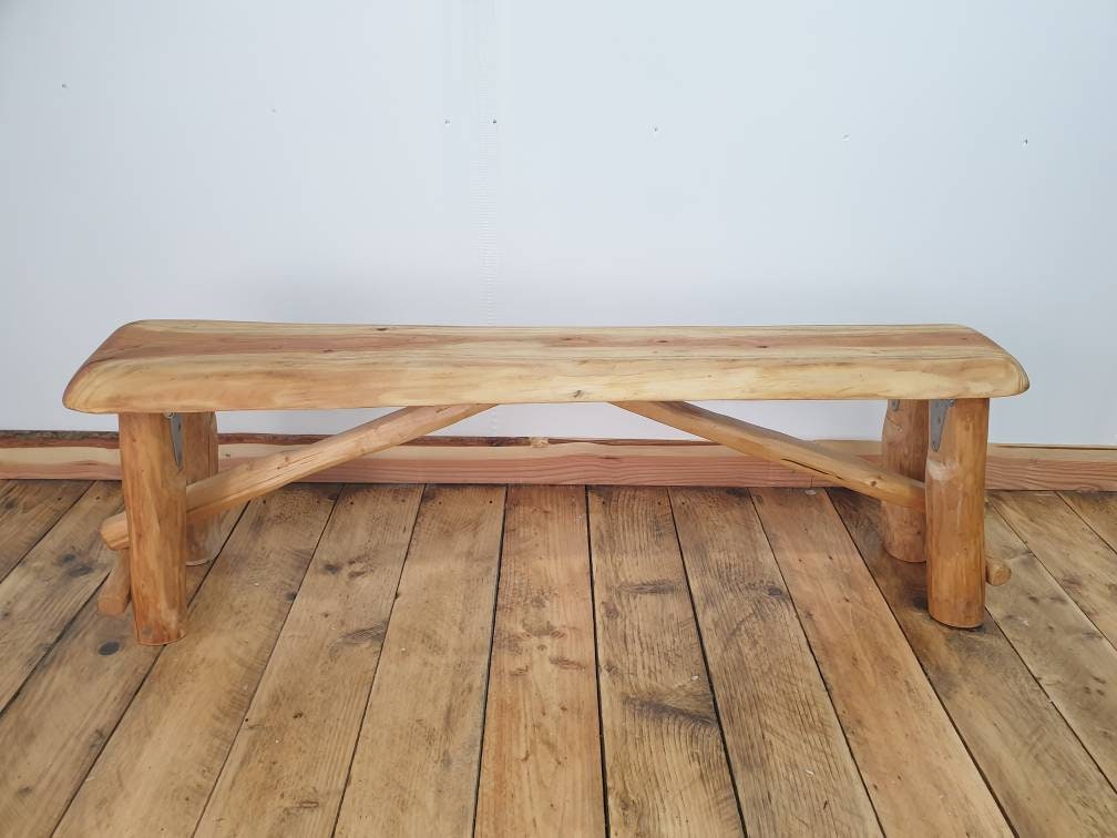a straight on view of a foldable garden bench in a studio