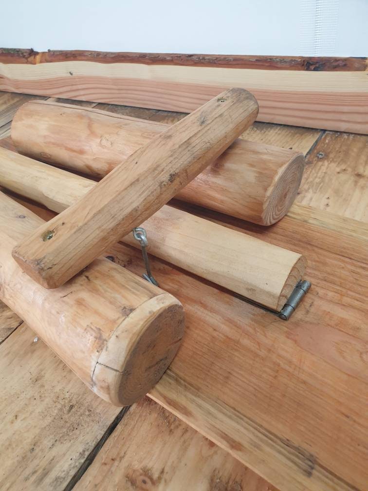 a closeup of the latch that keeps the legs of a folding garden bench closed when folded