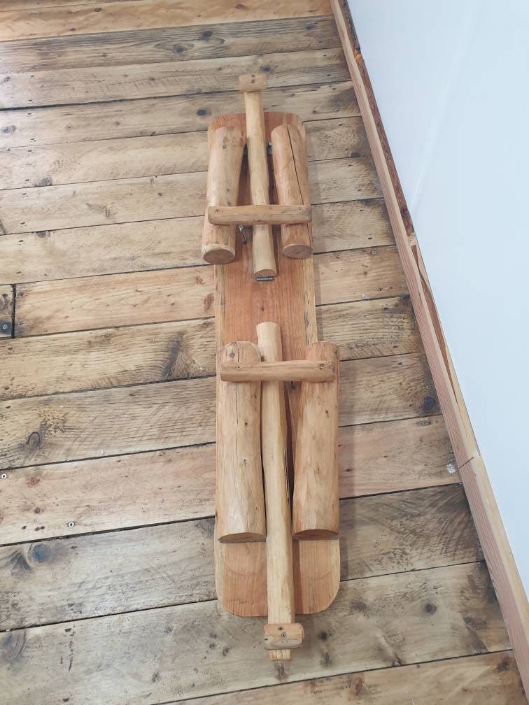 a view of a folded garden bench that has been folded up ans is ready for transport or storage
