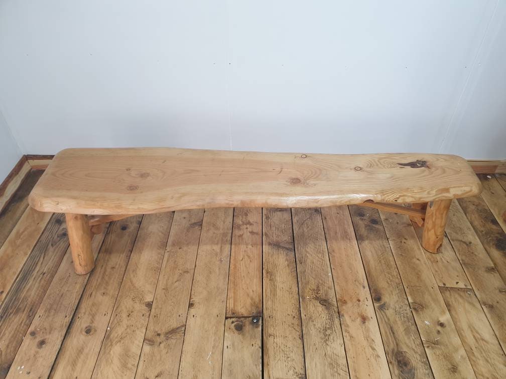 a view of a folding garden bench with an irregular width top