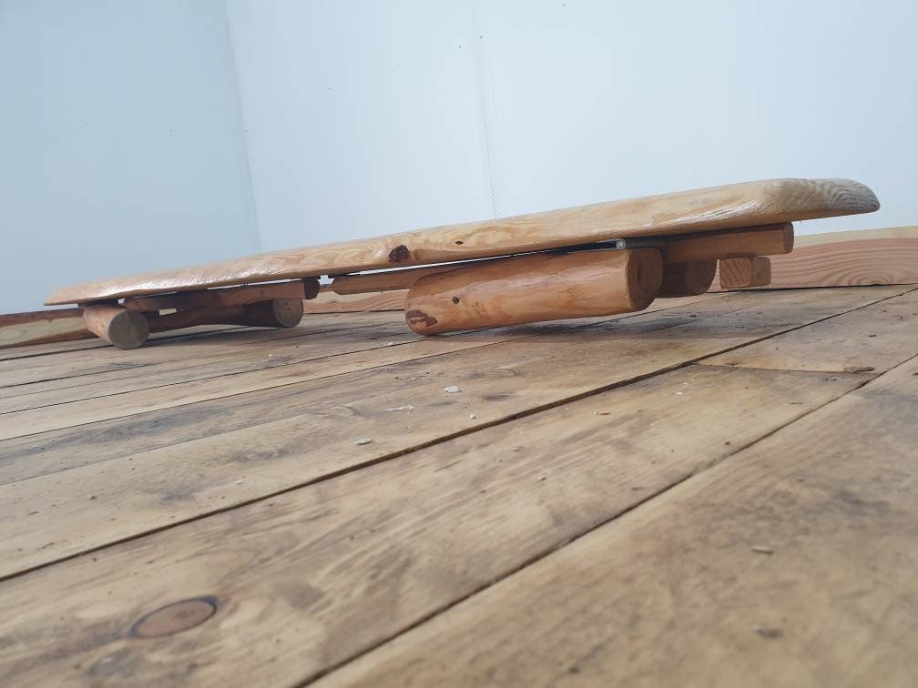 a low view of a folding garden bench that shows its height when folded