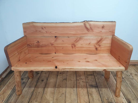 Front view of a solid back garden bench with arms