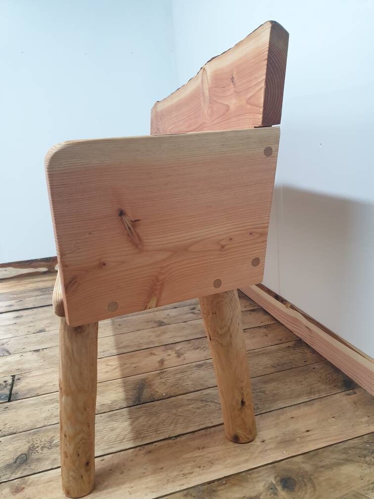 closeup of the arms on a solid backed garden bench