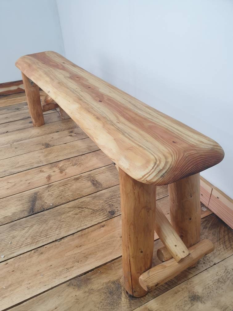 an angled view of a foldable garden bench in a studio