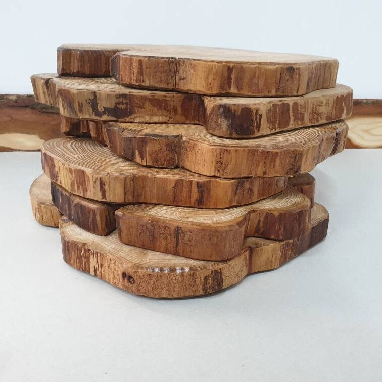 A stack of wooden log ring place mats showing off their live-edge detail