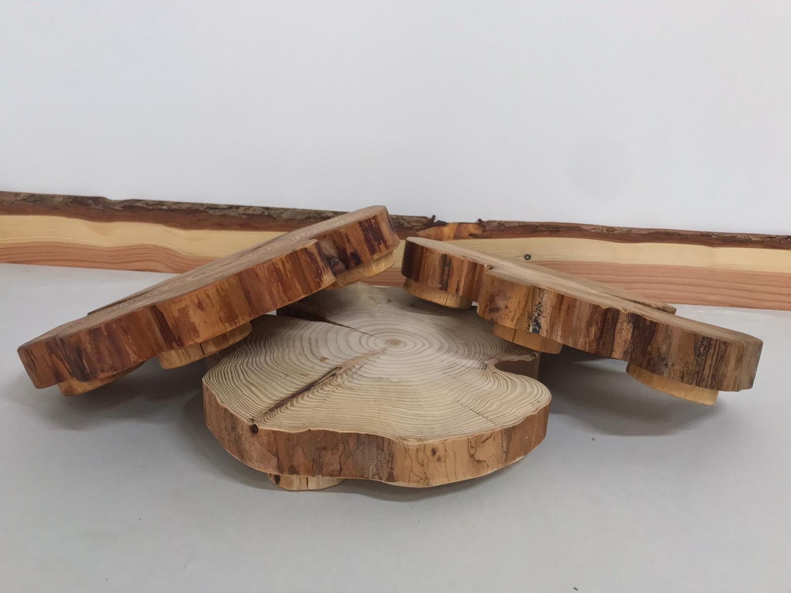 Two tables centerpieces gang up on a third, viciously stomping their poor comrade. Truly their hearts have turned to wood.