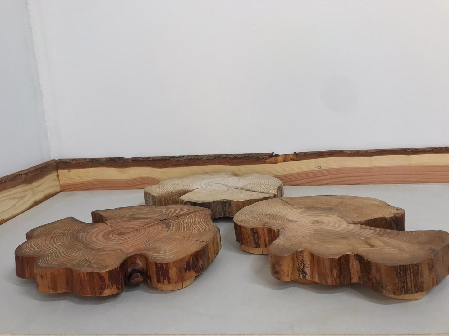 Three wooden table centerpieces patiently waiting for a bus.