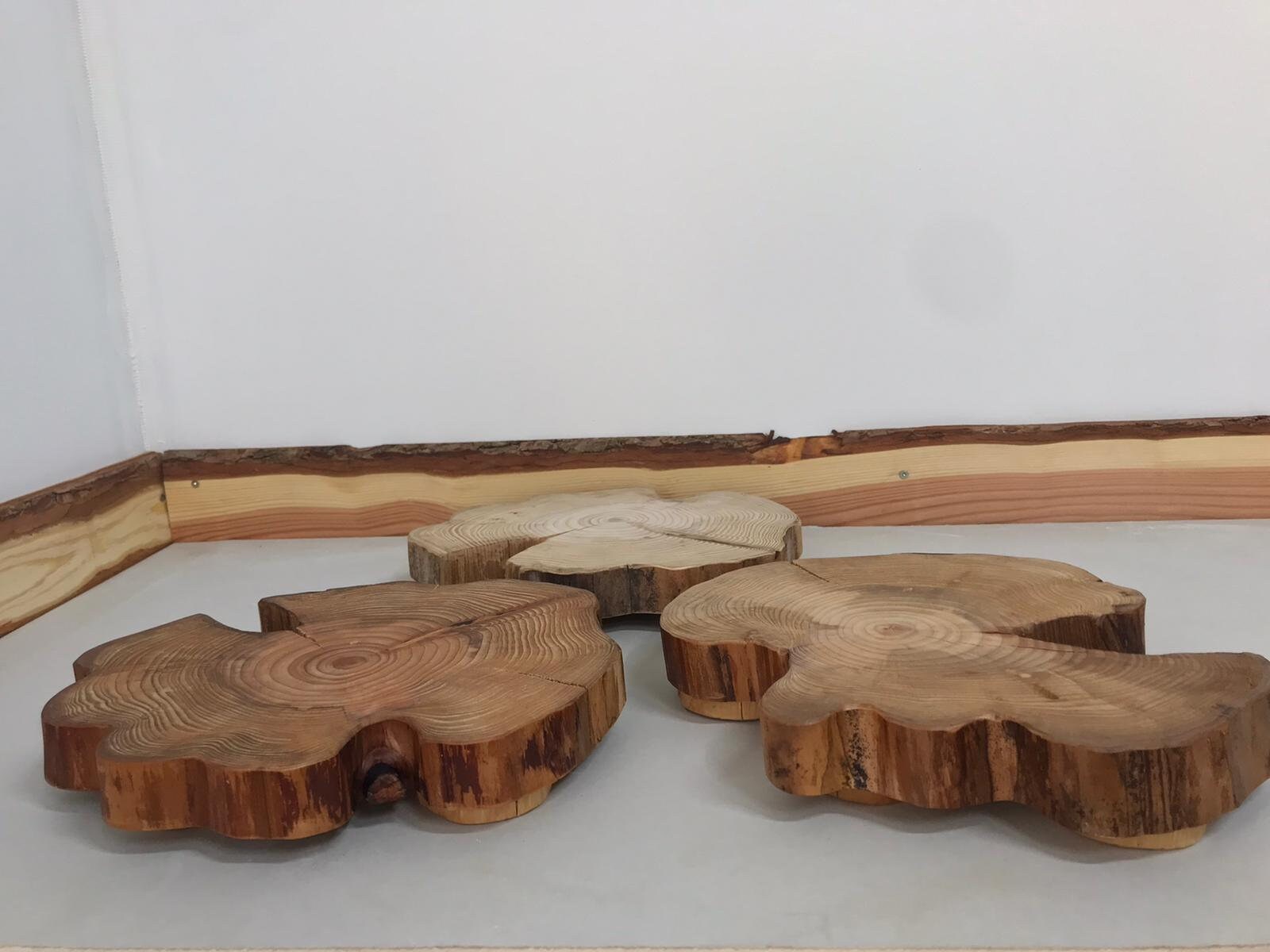 Three wooden table centerpieces patiently waiting for a bus.