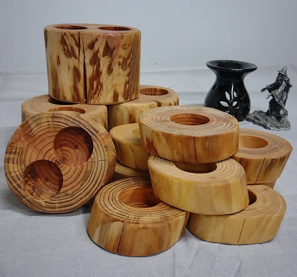 A pile of log tea light holders without candles.