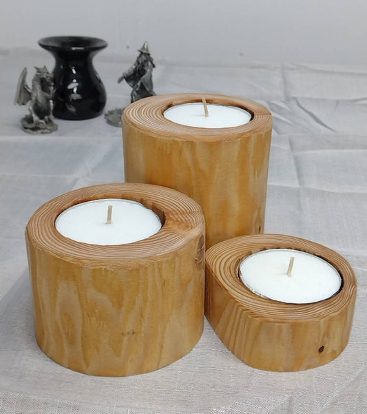 three log tea light holders with candles