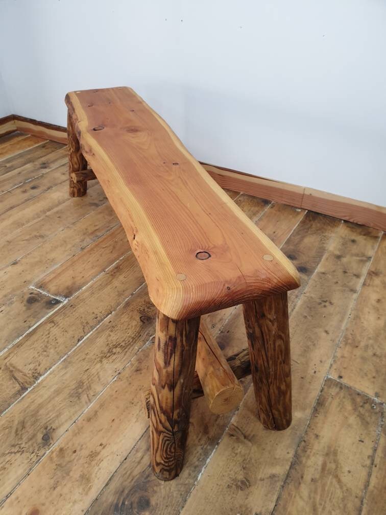end view of a bench with red heart wood top