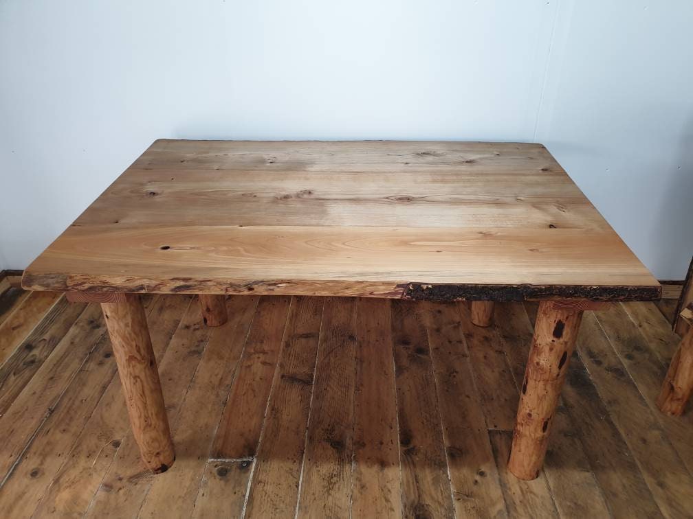 a large four-legged table in a studio