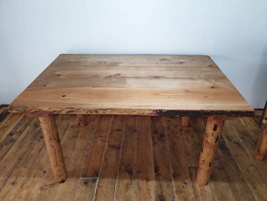 a large four-legged table in a studio