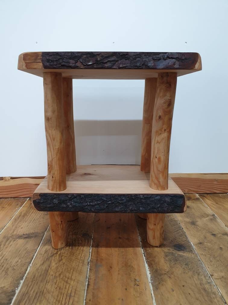 A front, level view of a live-edge wooden square end table