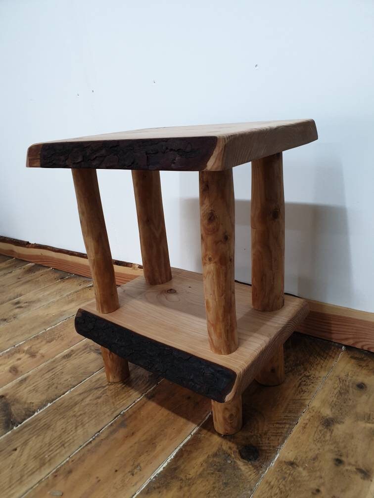 An angled view of a live-edge wooden bedside table