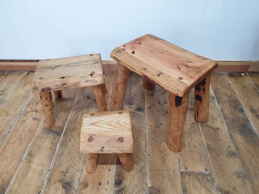 three rectangular wooden stools of various sizes