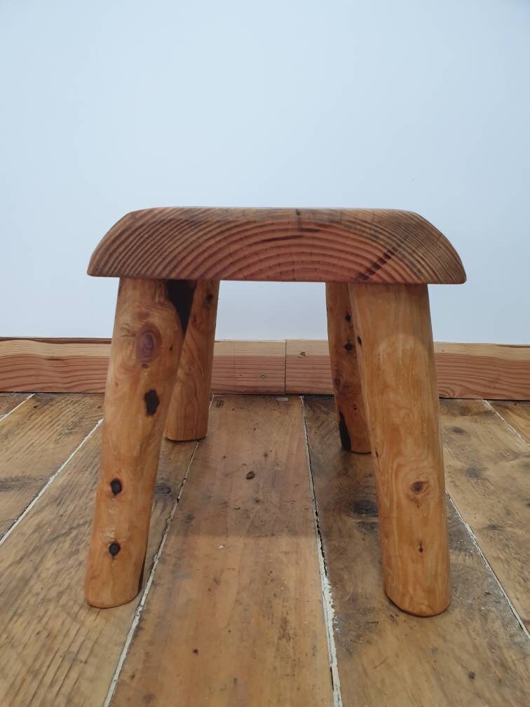 a side view of a wooden slab stool