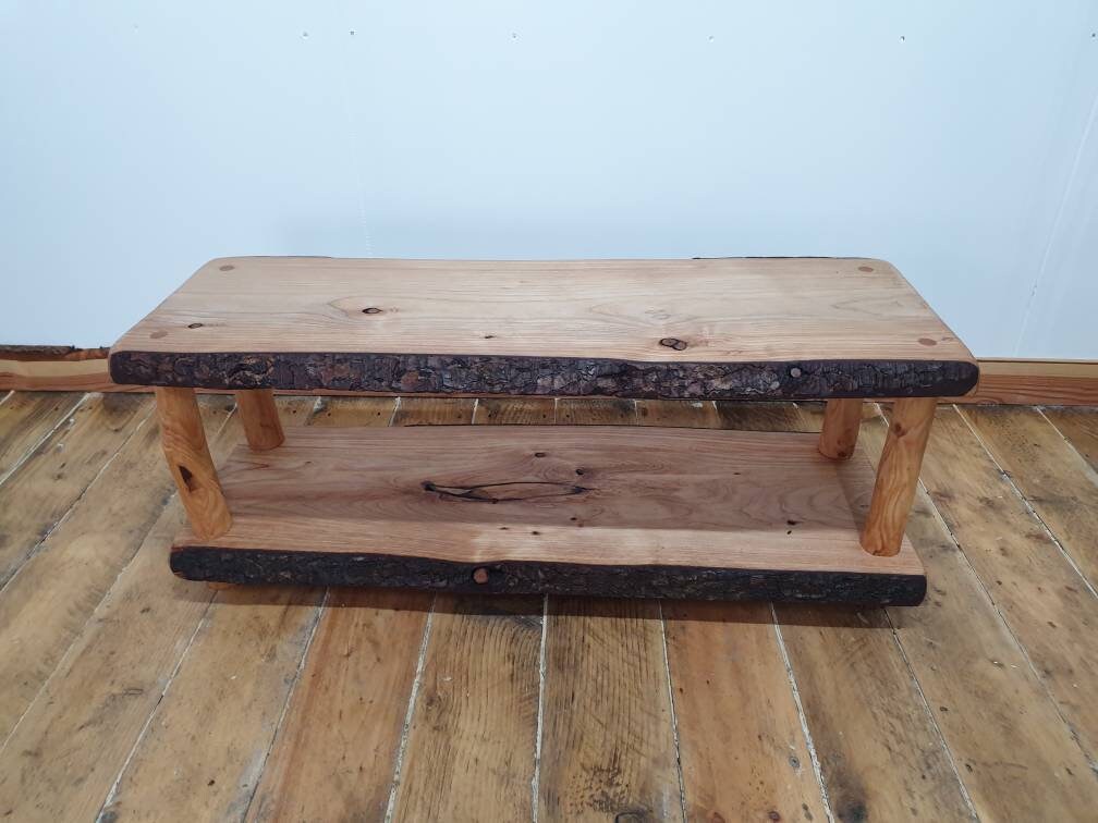 A wooden coffee table with an all bark live-edge