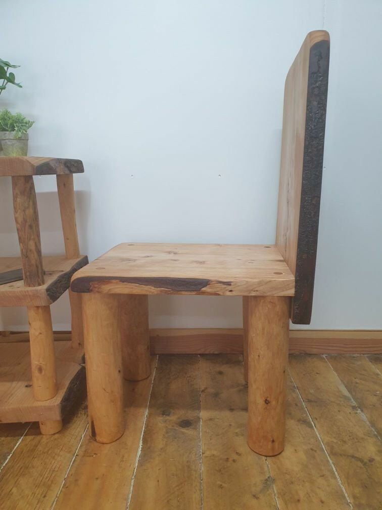 A side on view of a vertical backed chair that makes it easy to see the angle of the back