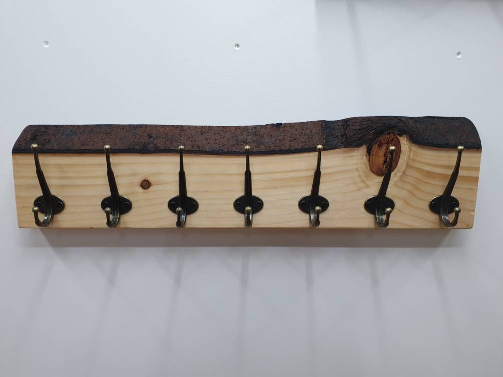 A front aspect of the 7 hook coat rack with the large natural knot to the one side.