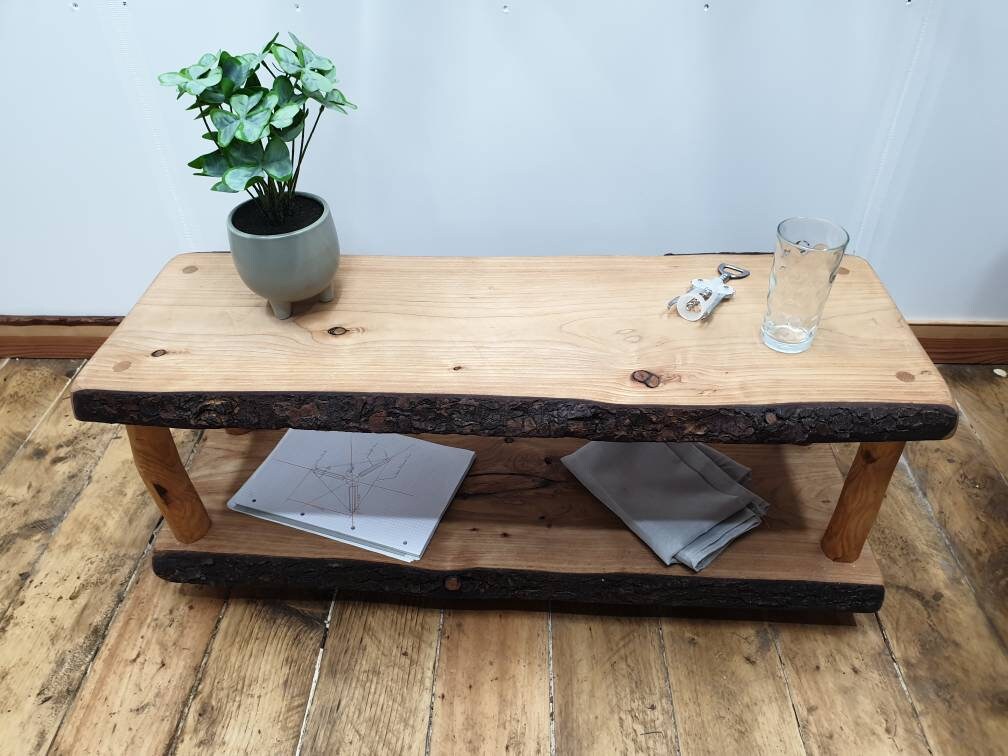 A wooden coffee table hard at work storing such wonderful items as a notepad, a glass and bottle opener (where's the bottle?), and a potted plant (I think it's fake). Sure am I glad I'm not having a mental breakdown.