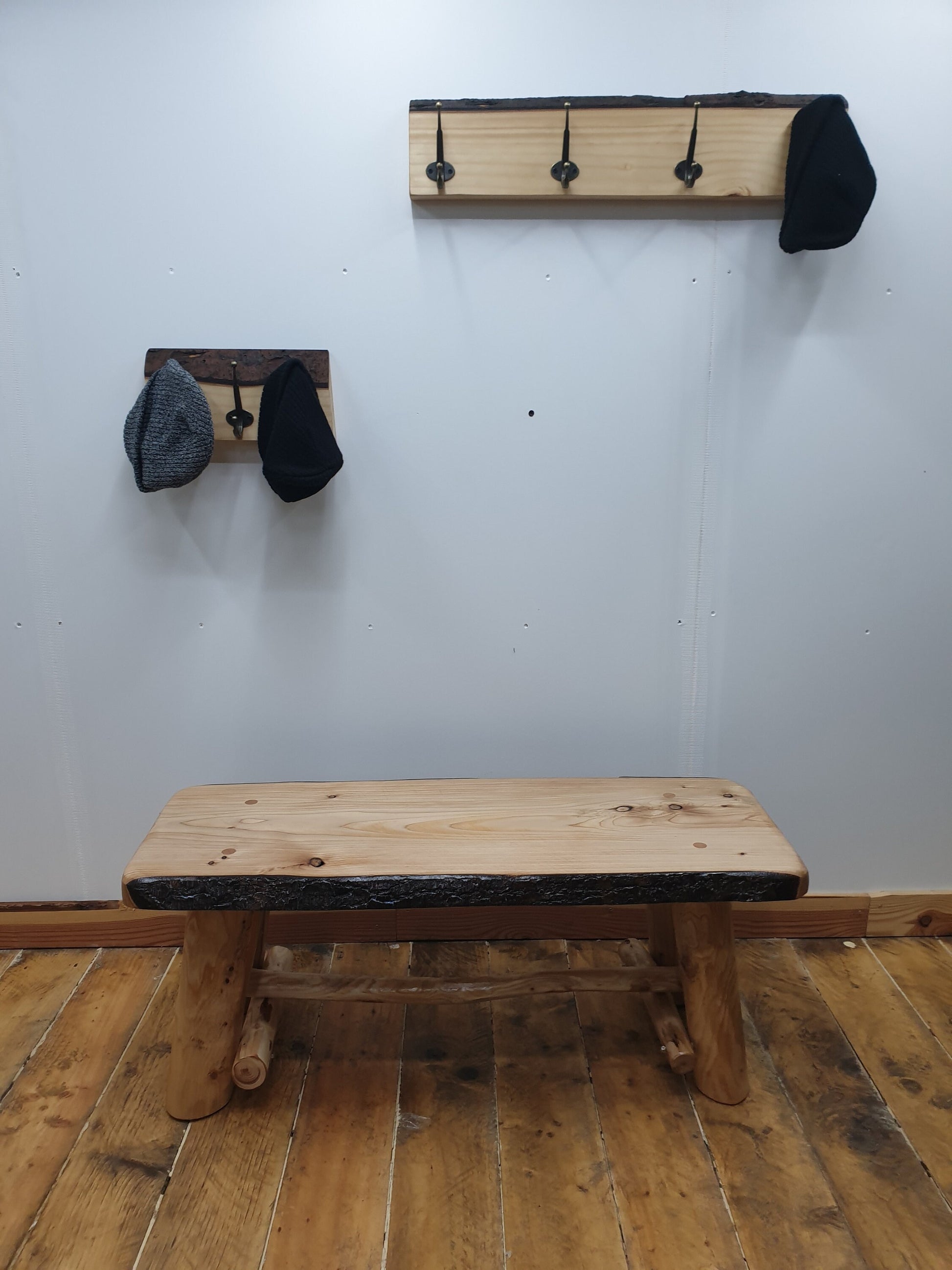 A short bench made from a live-edge wooden slab, varnished.