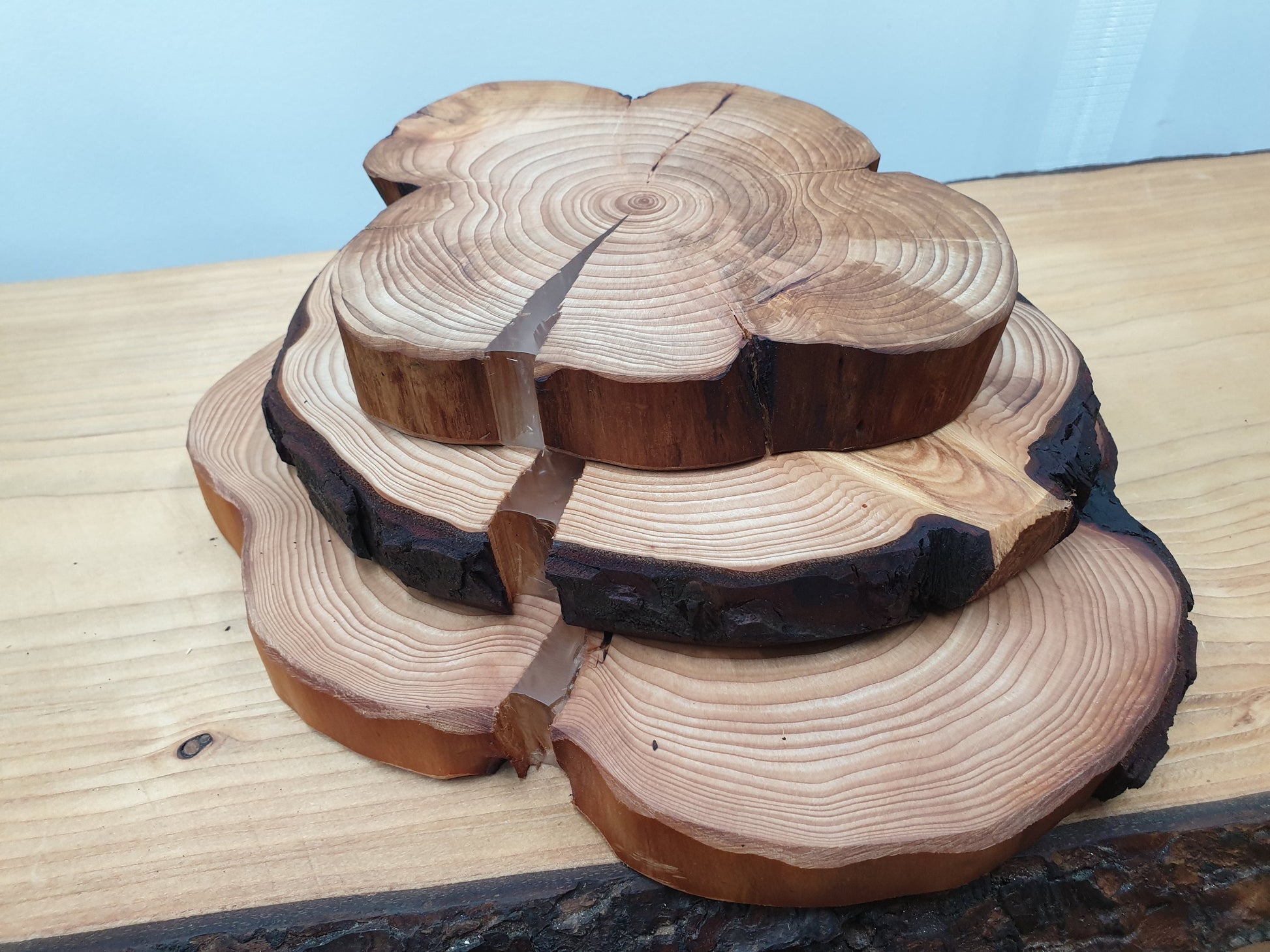 Three log ring centerpieces with splits filled with clear epoxy resin