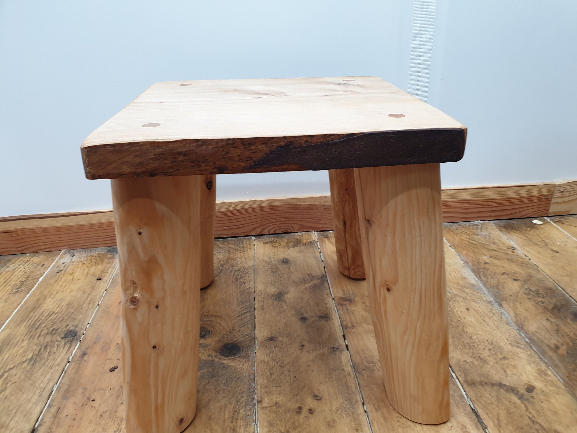 closeup side view of a medium square stool