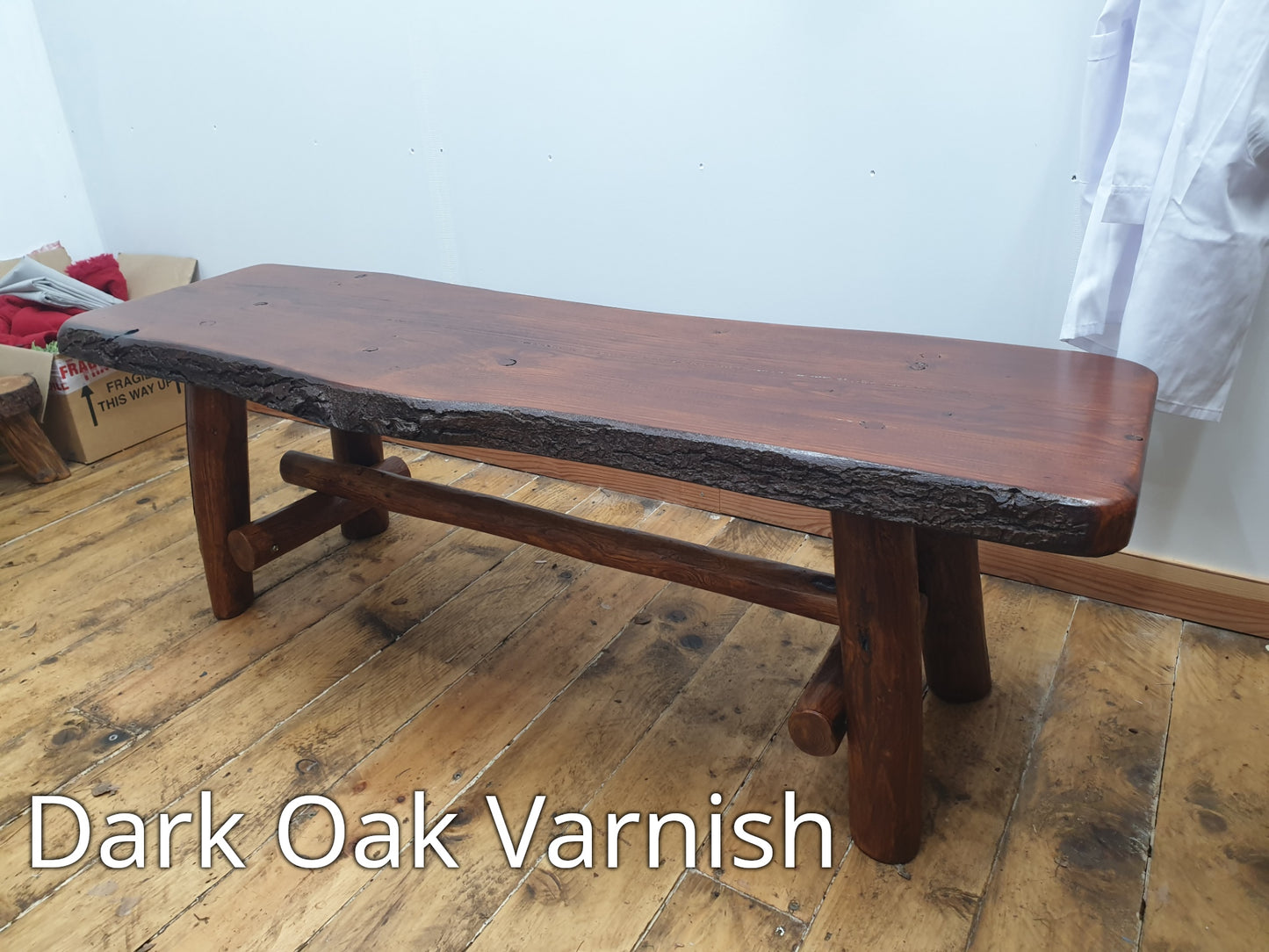 A wooden bench coated with a dark oak varnish.