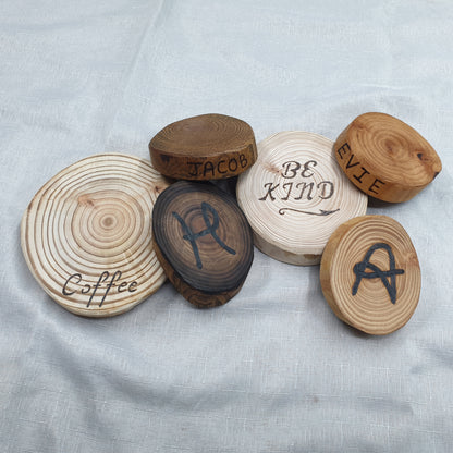 Wooden coasters with engraved text on a light fabric background