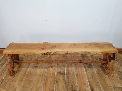 A front view of a wooden bench showing of the support beam underneath it.