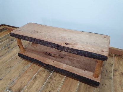 A view of a live-edge wooden coffee table unadorned 