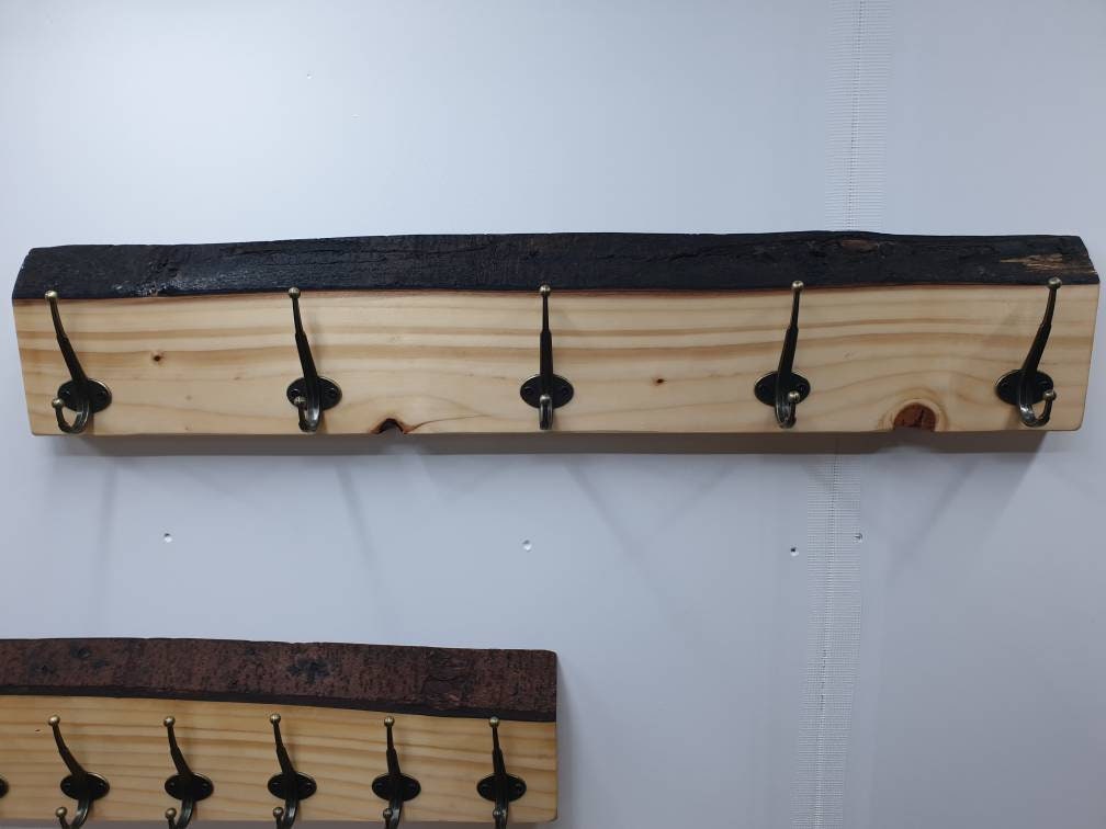 A front aspect of the 90cm coat rack with 5 widely spaced hooks. Its has a couple of visible knots and a very dark almost black bark.