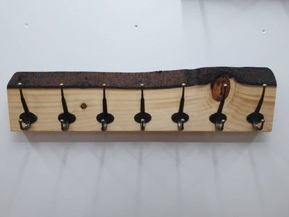 A front aspect of the 7 hook coat rack with the large natural knot to the one side.